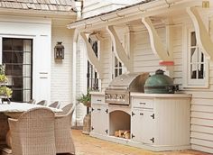 an outdoor kitchen and dining area is shown