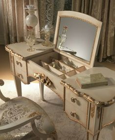 an antique dressing table with mirror and stool