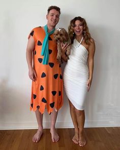 a man and woman dressed up as flint and pebbles from the flint family, standing next to each other