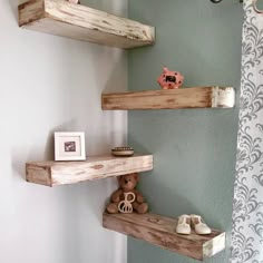 two wooden shelves in the corner of a bathroom