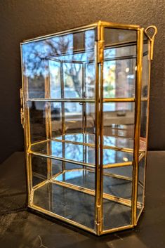 a glass display case sitting on top of a table