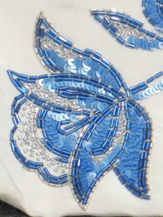 a white pillow with blue and silver designs on it