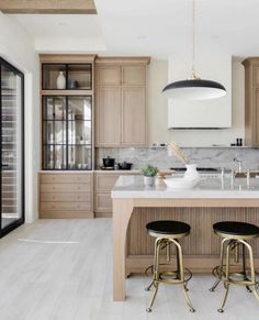 a large kitchen with wooden cabinets and marble counter tops is featured in the magazine's march issue