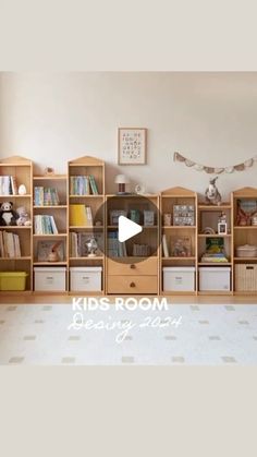 a kid's room with bookshelves and toys on the floor in front of it