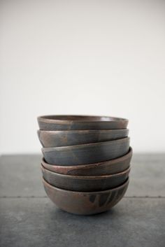 five brown bowls stacked on top of each other