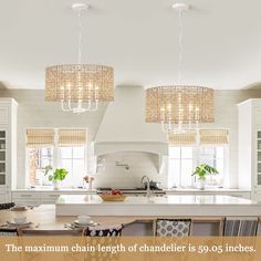 a kitchen with chandeliers hanging from the ceiling and an island in the middle