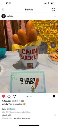 a bucket of food sitting on top of a table next to a sign that reads chumm bucket