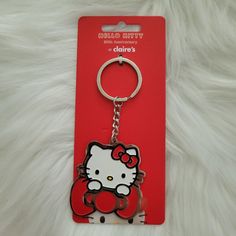 a hello kitty keychain is shown on a white furnishing area with a red tag