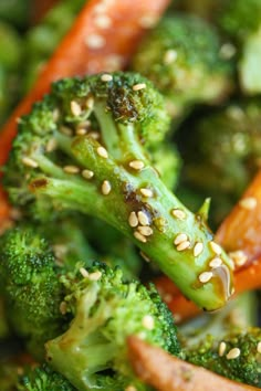 broccoli and carrots with sesame seeds in a stir - fry dish, ready to be eaten