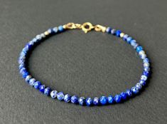 This minimalist bracelet is made with genuine, faceted Lapis Lazuli gemstones (3mm), and 14k gold filled accent beads. It is finished with 14k gold filled spring ring clasp.     💎    D E T A I L S * Handmade in Canada * Lapis Lazuli faceted gemstone beads (3 mm) * 14k gold filled beads (2.5mm) * 14k gold filled spring ring clasp * Gemstones are 100% genuine 💎LENGTH This bracelet is 7 inches long. 💎    LAPIS LAZULI A stone of wisdom, intuition, and truth, Lapis Lazuli is a powerful crystal for Gemstone Wrap Bracelet, Lapis Lazuli Bracelet, Bracelet Dainty, Power Crystals, Minimalist Bracelet, Faceted Gemstones, Bracelet Stack, Gemstone Bracelet, Bracelet Gift