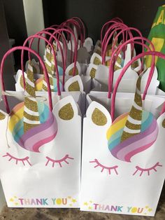 unicorn themed party bags with pink handles and gold glitter on the top, thank you