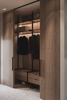 an open closet with clothes hanging in it