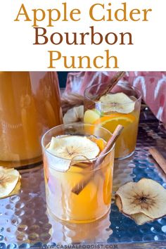 an apple cider bourbon punch is garnished with sliced bananas and cinnamon