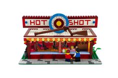 a lego model of a hot dog stand with people standing in front of the building