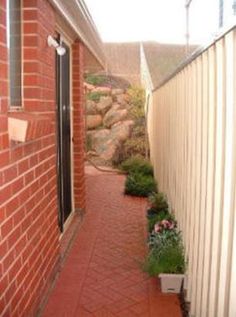 a narrow brick walkway between two buildings