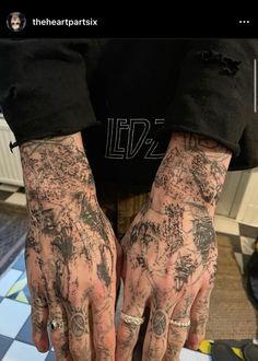 a person with tattoos on their arms and hands