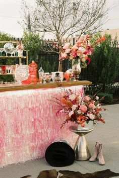 an outdoor bar with pink and white decor