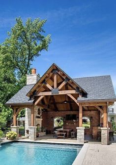 a pool with a covered patio next to it and a swimming pool in the middle