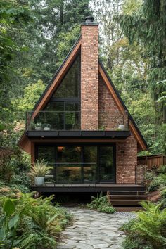 a house in the woods surrounded by greenery and stone walkway leading up to it