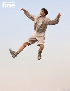 a man flying through the air while riding on top of a skateboard in front of a blue sky