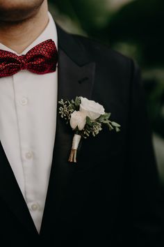 a man in a tuxedo with a boutonniere on his lapel