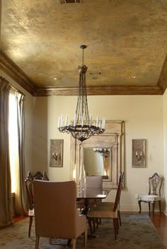 an elegant dining room with chandelier and chairs