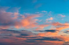 the sky is filled with pink and blue clouds