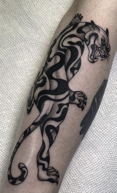 a black and white tiger tattoo on the arm