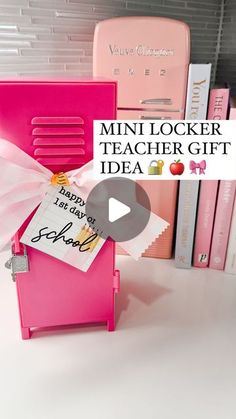 a pink locker with a note attached to it in front of some books and other items