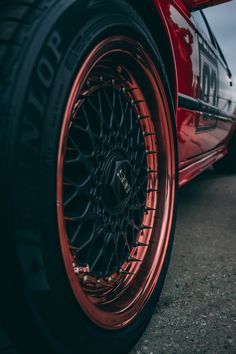 the rims and tires of a red sports car