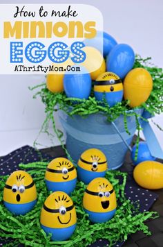 an arrangement of minion eggs in a bucket with green grass and blue balls around them