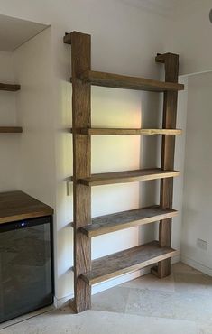 an empty room with some shelves and a tv