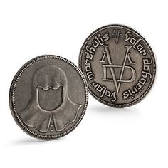 an old silver coin with the image of a man's head on it, in front of a white background