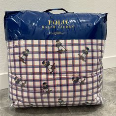 a blue and white plaid bag with bees on it