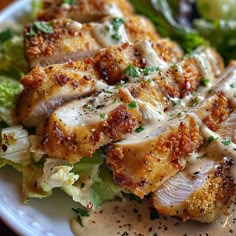 a white plate topped with chicken and lettuce