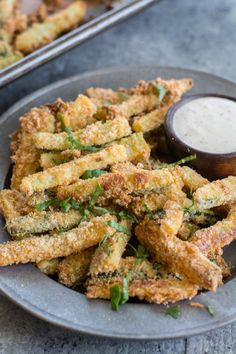 some fried food on a plate with dipping sauce