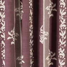 the curtain is made up of purple and white fabric with an intricate design on it