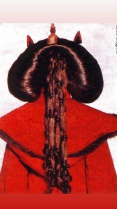 the back of a woman's head with long hair and horns on her head