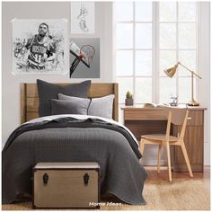 a bed room with a neatly made bed and pictures on the wall