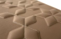 a close up view of the back side of a leather couch with stitching on it