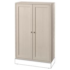 a tall white cabinet with two doors