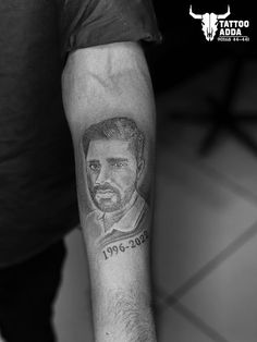 a man with a tattoo on his arm that has a photo of himself in it