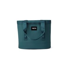 a teal tote bag with the word yet on it