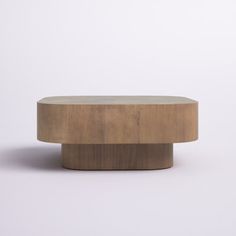 a round wooden table on a plain white background with no one around it or someone else