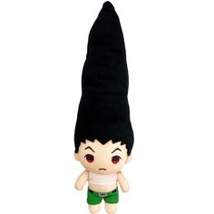 a small stuffed doll with a black hat and green shorts on it's head