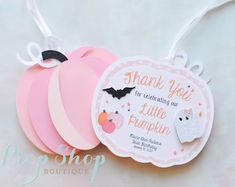 some pink and white tags are hanging from a string on a table with the tag saying thank you for celebrating our little pumpkin