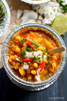 two bowls filled with food on top of a table