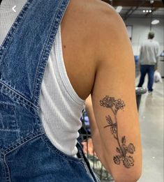 a woman with a flower tattoo on her arm