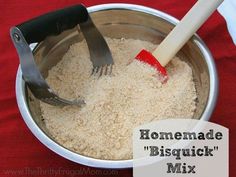 a metal bowl filled with brown rice and a red spatula on top of it