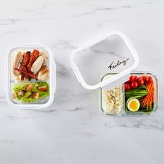 two plastic containers filled with food sitting on top of a white marble countertop next to each other